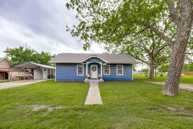 bungalow-style home with a detached carport, driveway, and a front yard