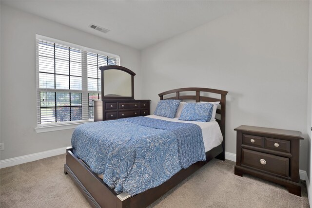 bedroom with baseboards, carpet, and visible vents