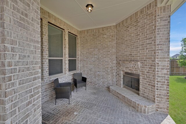 view of patio featuring an outdoor brick fireplace
