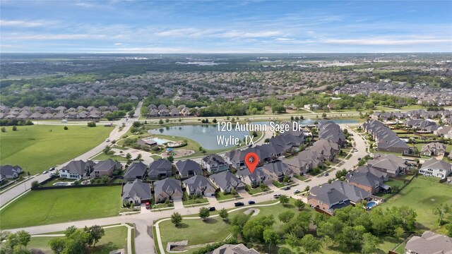 drone / aerial view featuring a water view and a residential view