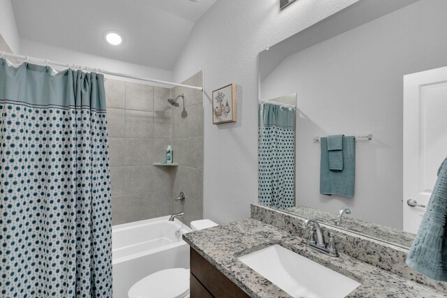bathroom with vanity, toilet, and shower / tub combo
