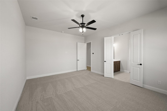 unfurnished bedroom featuring baseboards, light carpet, a ceiling fan, and visible vents