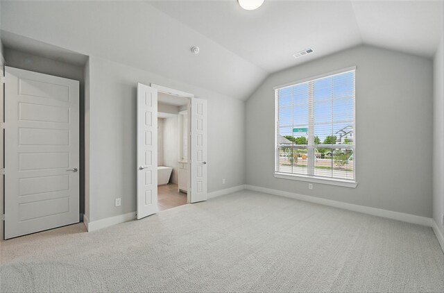 1000 Tulip Pl, Crowley, TX 76036 - unfurnished bedroom with carpet, lofted ceiling, baseboards, and ensuite bathroom