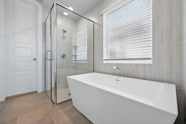 1000 Tulip Pl, Crowley, TX 76036 - bathroom featuring tile patterned floors, a shower stall, healthy amount of natural light, and a freestanding bath