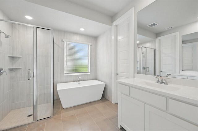 1000 Tulip Pl, Crowley, TX 76036 - full bath featuring a shower stall, tile patterned flooring, vanity, a freestanding bath, and recessed lighting