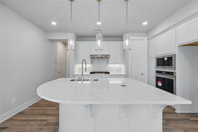1000 Tulip Pl, Crowley, TX 76036 - kitchen featuring a sink, built in microwave, white cabinetry, decorative backsplash, and recessed lighting