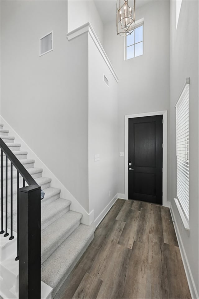1000 Tulip Pl, Crowley, TX 76036 - entrance foyer with stairs, a chandelier, baseboards, wood finished floors, and a high ceiling