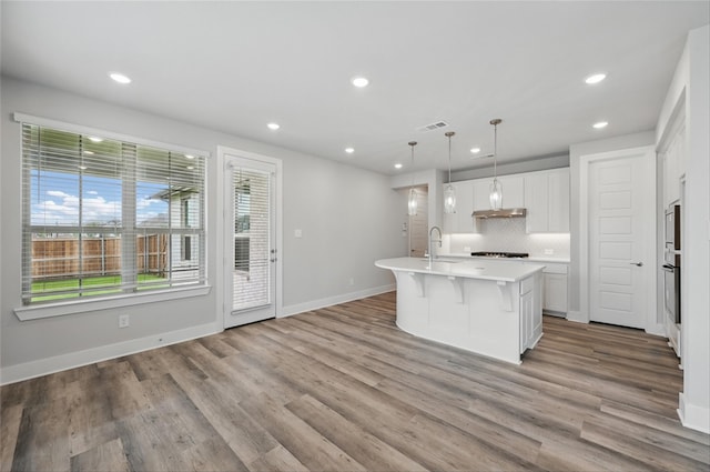 1000 Tulip Pl, Crowley, TX 76036 - kitchen with recessed lighting, backsplash, light countertops, a sink, and a center island with sink