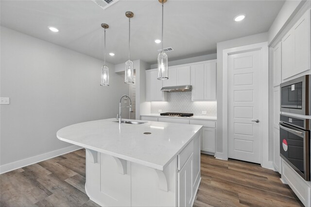 1000 Tulip Pl, Crowley, TX 76036 - kitchen featuring stainless steel oven, a sink, built in microwave, gas stovetop, and a kitchen island with sink