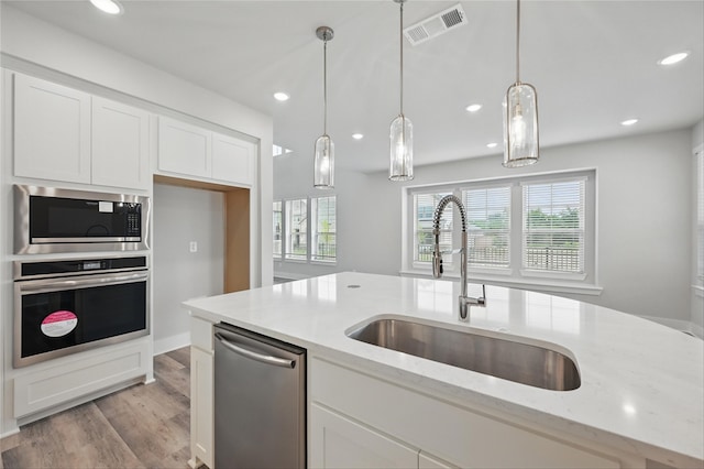 1000 Tulip Pl, Crowley, TX 76036 - kitchen featuring stainless steel appliances, a sink, white cabinetry, light wood-type flooring, and recessed lighting