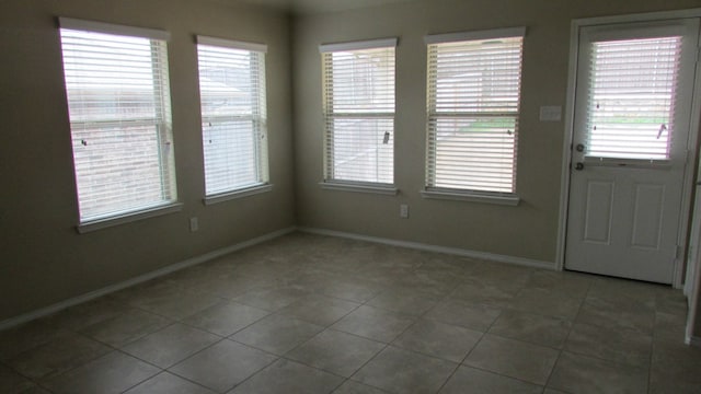 interior space with baseboards and plenty of natural light