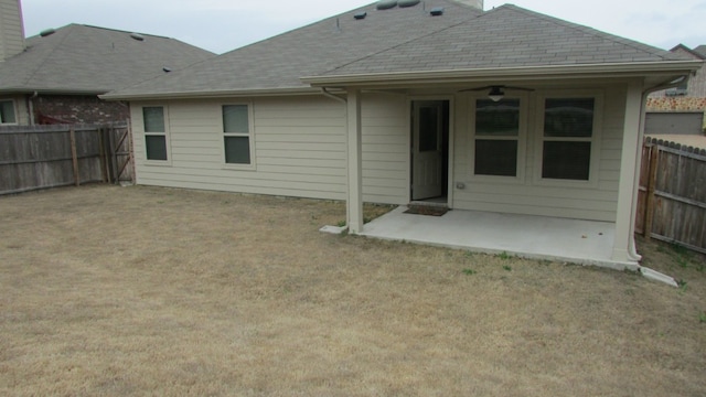 back of house with a fenced backyard and a patio