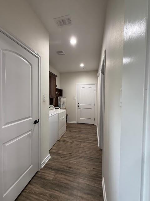 corridor with recessed lighting, baseboards, dark wood-style flooring, and washing machine and clothes dryer