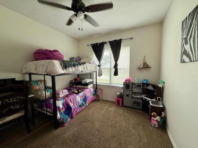 bedroom with baseboards, carpet, and a ceiling fan