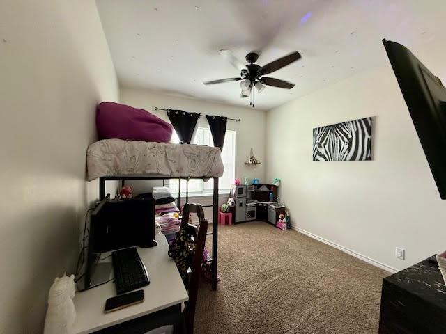 carpeted bedroom with baseboards
