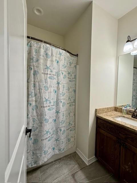 full bathroom featuring tile patterned floors, curtained shower, and vanity