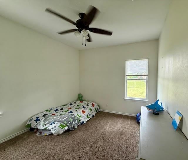 bedroom with carpet flooring, baseboards, and ceiling fan