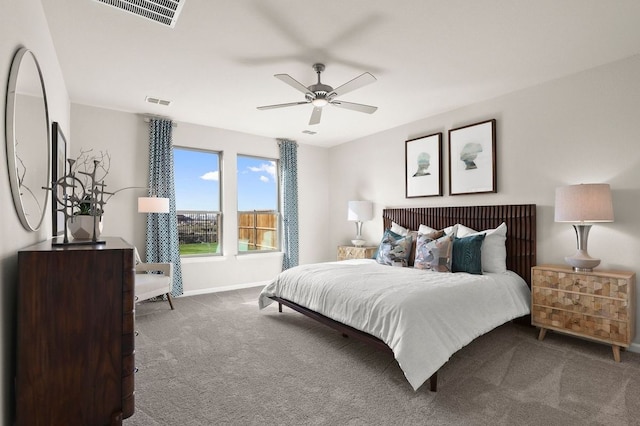 carpeted bedroom with visible vents, a ceiling fan, and baseboards