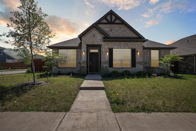 view of front of house featuring stone siding and a front yard
