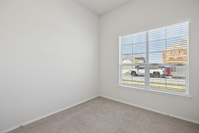 carpeted empty room with baseboards