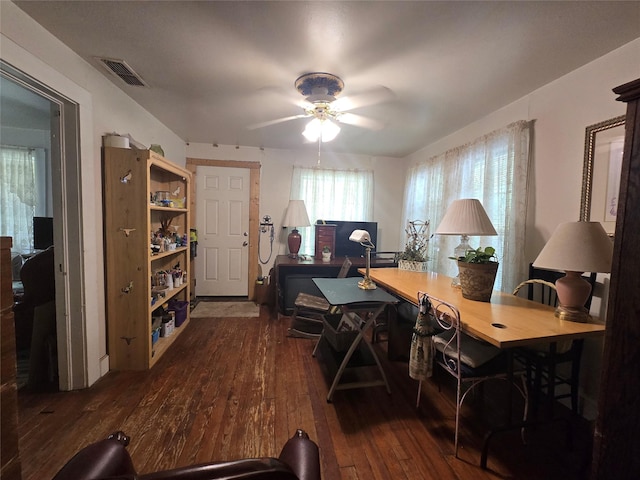 office space featuring visible vents, dark wood-type flooring, and ceiling fan