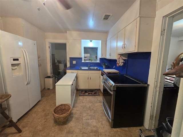 kitchen featuring electric range, visible vents, a sink, white fridge with ice dispenser, and white cabinetry