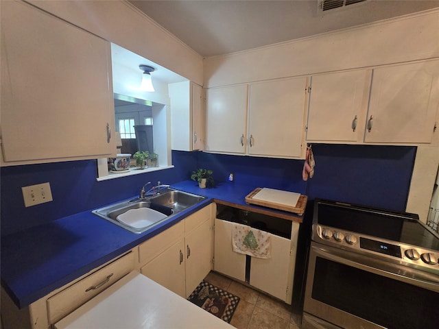 kitchen with visible vents, a sink, light tile patterned floors, electric stove, and white cabinetry