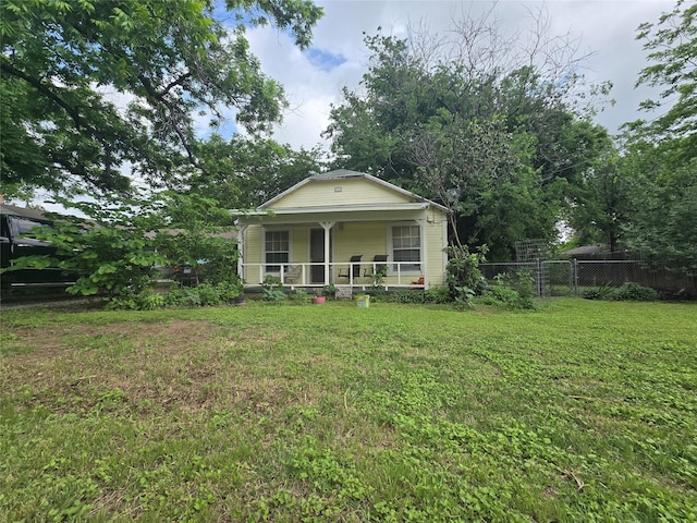 bungalow featuring a front lawn, fence, and covered porch