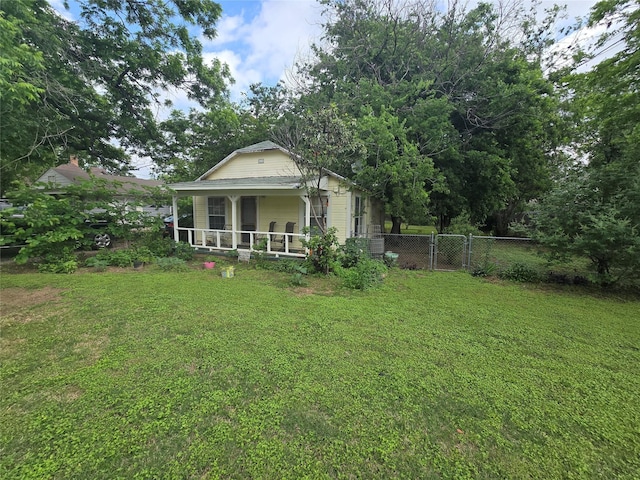 exterior space featuring a yard, fence, and a porch