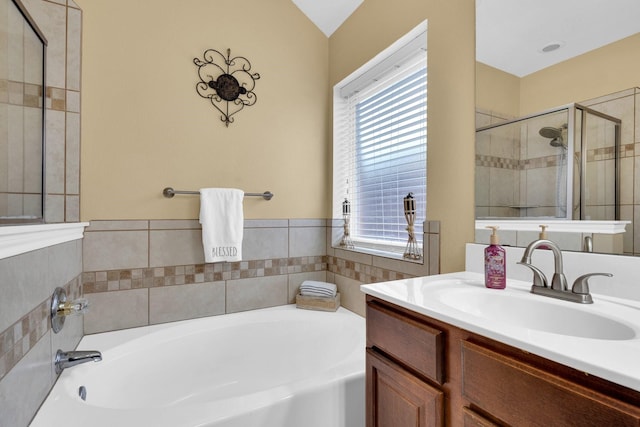 bathroom with a shower stall, a garden tub, and vanity