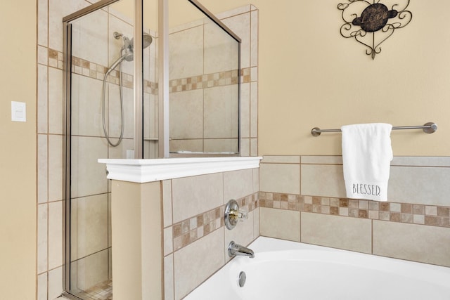 full bath with a shower stall and a garden tub