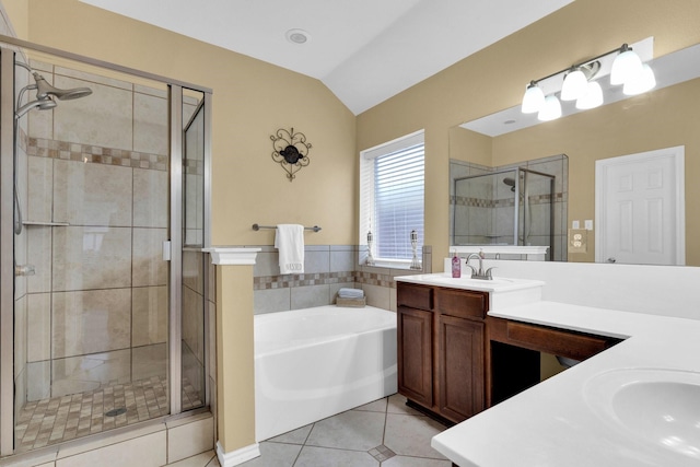 full bathroom featuring a bath, tile patterned flooring, vaulted ceiling, a stall shower, and vanity