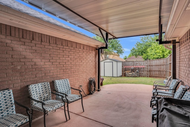 view of patio / terrace with a fenced backyard, a storage unit, and an outdoor structure