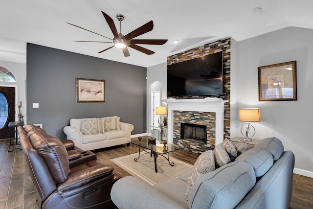 living area featuring ceiling fan, a stone fireplace, baseboards, recessed lighting, and dark wood-type flooring