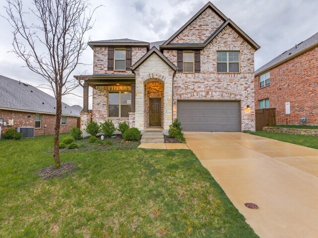 view of front of house featuring a garage, driveway, and a front yard