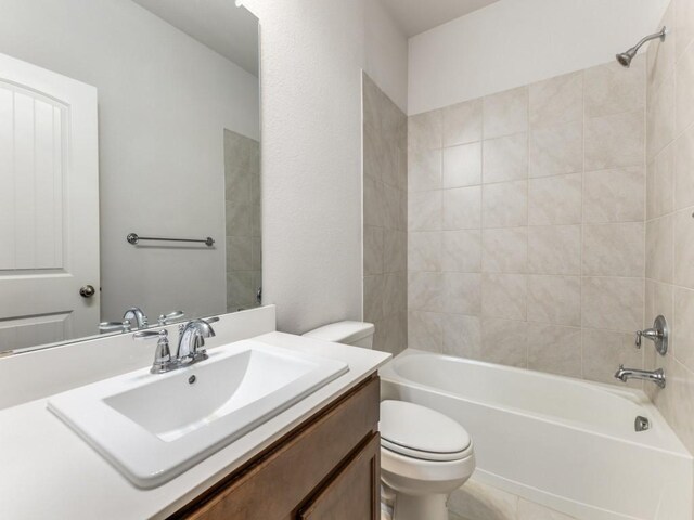 bathroom featuring vanity, tub / shower combination, and toilet