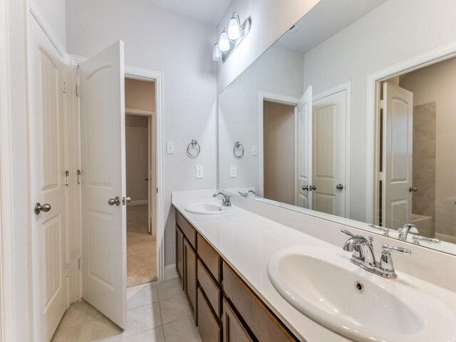 bathroom with a sink, tile patterned flooring, and double vanity