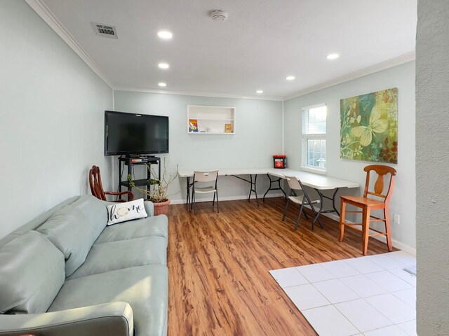 living room with crown molding, recessed lighting, visible vents, and wood finished floors