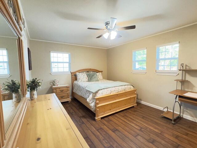 bedroom featuring crown molding, baseboards, multiple windows, and dark wood-type flooring