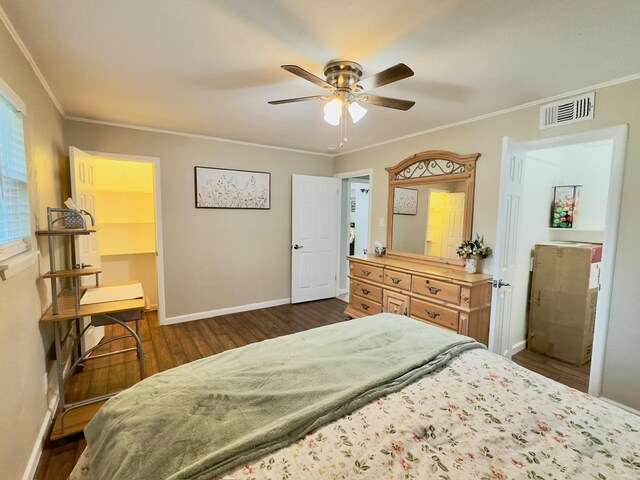 bedroom featuring ceiling fan, visible vents, crown molding, dark wood finished floors, and baseboards