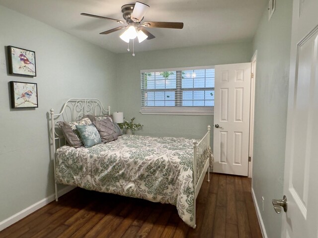bedroom featuring baseboards, ceiling fan, and dark wood-style floors