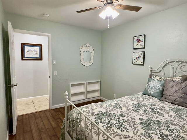 bedroom with baseboards, a ceiling fan, and hardwood / wood-style flooring