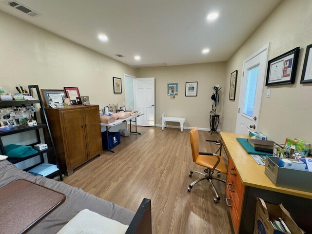 office featuring visible vents, recessed lighting, baseboards, and light wood-type flooring