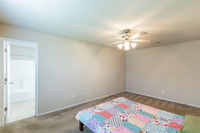 carpeted bedroom featuring visible vents, connected bathroom, baseboards, and ceiling fan