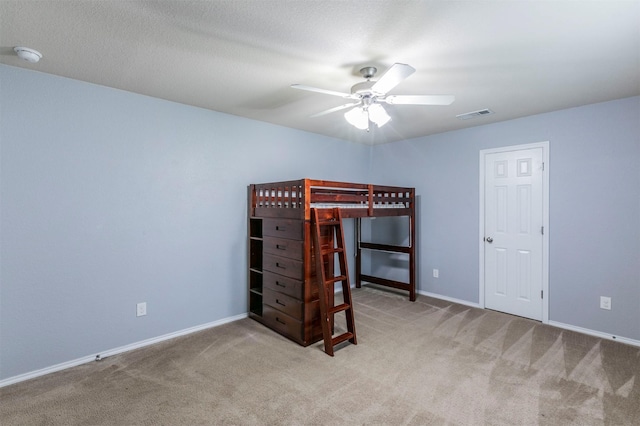 carpeted bedroom with a ceiling fan, baseboards, and visible vents