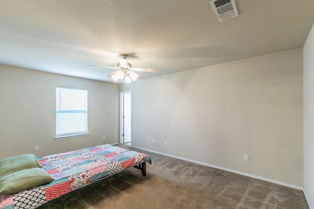 carpeted bedroom featuring baseboards, a ceiling fan, a textured ceiling, and visible vents