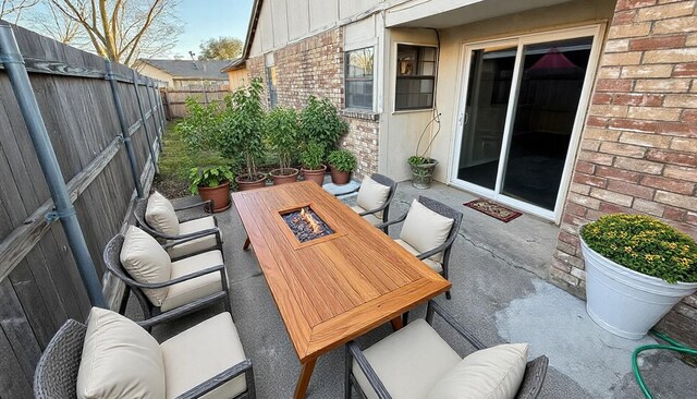 view of patio / terrace with a fenced backyard and an outdoor fire pit