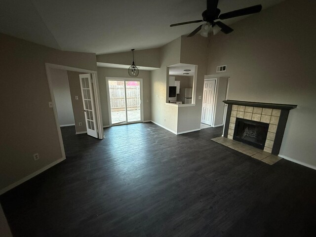 unfurnished living room featuring baseboards, a ceiling fan, vaulted ceiling, and visible vents