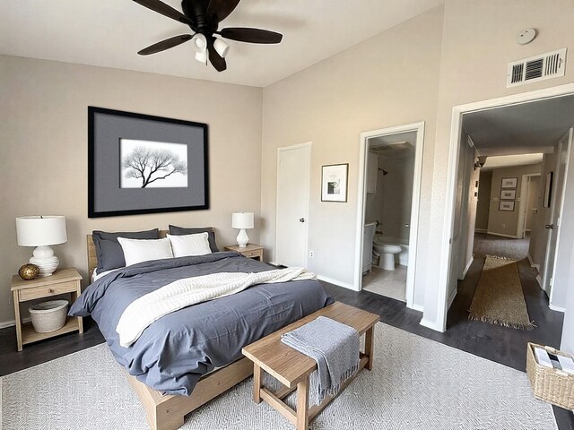 bedroom with visible vents, ensuite bathroom, baseboards, a ceiling fan, and dark wood finished floors
