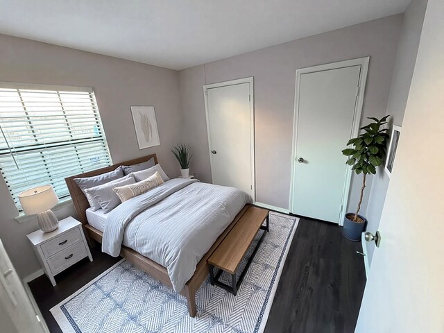 bedroom with dark wood-style flooring